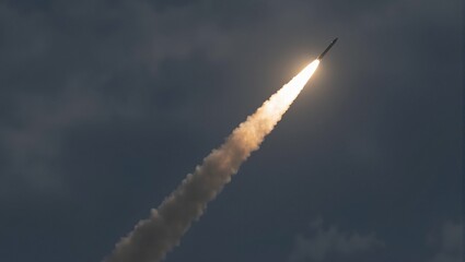 Rocket missile with exhaust trail against dark sky