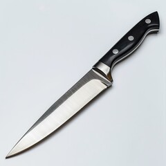 Fototapeta premium A sharp stainless steel kitchen knife with a black handle, isolated on a white background.