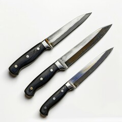 Three kitchen knives with black handles and metallic blades arranged on a white background.