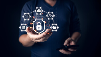 A person holding a glowing shield icon symbolizing cyber security, surrounded by connected digital...
