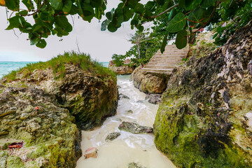 
Holgin Province, Cuba, Gardalavaca beach, magnificent view of an exotic section of the beach with big round oval rocks with ocean stream between them in tropical garden
