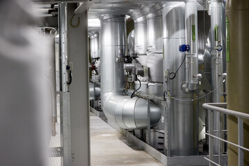 Modern Heating Plant Interior with Steel Pipelines and Advanced Control Systems – Efficient Energy Infrastructure in Industrial Environment.