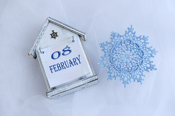 Calendar for February 8: decorative calendar, blue snowflake, numbers 08, name of the month...