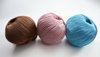 three vibrant yarn balls in brown pink and blue arranged on a white background for knitting or crafting white background