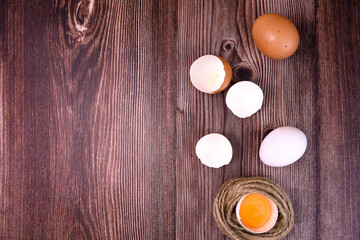whole and broken eggs on the table surface