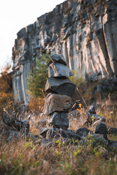 Closeup Of Small Rocks Balanced On Each Other With Basalt Columns In The Background. Rock Balancing
