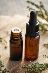 Thyme essential oil in two glass bottles