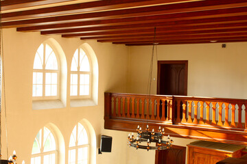 An old, wooden two-story house with a balcony inside