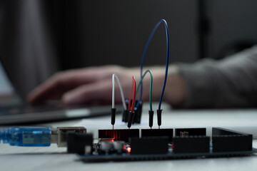 Man learns the basics of programming microprocessors close up