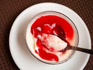 Vegan Panna cotta with cranberry sauce. Healthy vegan dessert