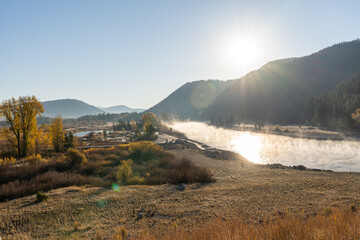 Morning Mist Over River in Grand Teton National Park with Sunlit Mountain Views.
