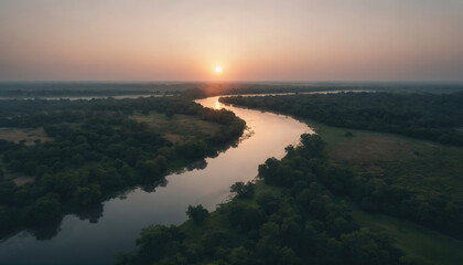 Fototapeta premium Sunset over a winding river reflecting golden hues in a tranquil landscape