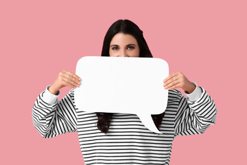 Young woman with blank speech bubble on pink background