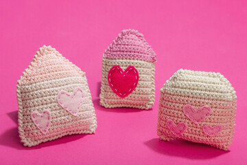 Handmade Valentines Day concept. Creative house figurines, traditional hearts, spring crocheting