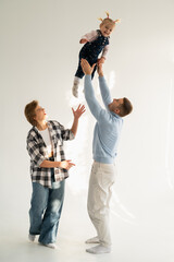 Mom and dad playing with a child on a white background