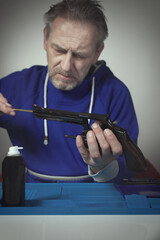 Man take care of six inch revolver caliber .357 magnum at home