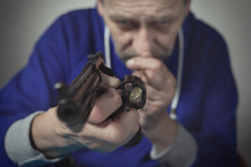 Man take care of six inch revolver caliber .357 magnum at home