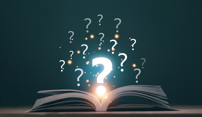 Education for new knowledge concept. Open book on wooden floor with question marks above....