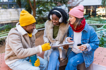 Group of diverse friends planning a trip in winter city
