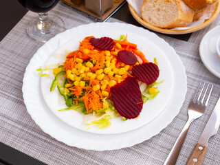 Image of a delicious light vegetable salad made from corn, chopped bell peppers, beets, onions and worn carrots