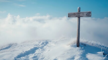 A wooden signpost stands solitary on a snow-covered hill.