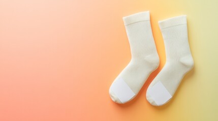 Cream socks with blank labels on pastel background.