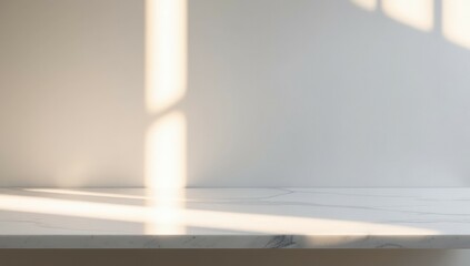 Empty marble surface with gray texture or pattern om white background or wall with sunlight. Gentle shadows create a calming ambiance, reflecting simplicity and tranquility.