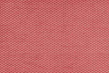 Fototapeta premium Plain red jacquard upholstery fabric, satin material with woven structure, pattern texture background. Close up, macro cloth textile surface. Wallpaper, backdrop with copy space