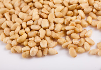 Pile of delicious pine nuts on a white surface