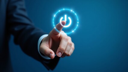 Hand pressing glowing power button on blue background
