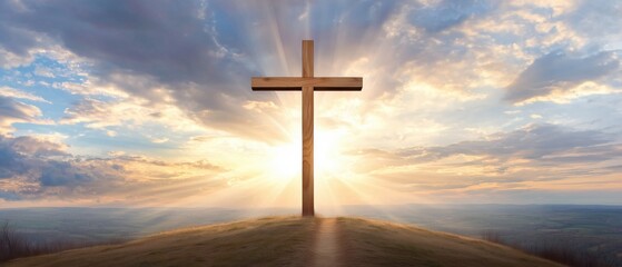 Wooden cross of Jesus Christ faith religion standing on a hill during sunrise cloudy sky with a path road.