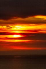 Sunset over the Atlantic Ocean. Dramatic Sky with Clouds and Sun