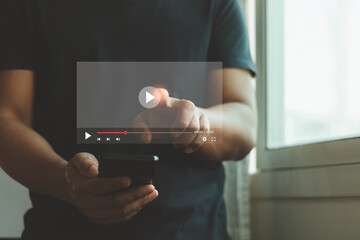 Video streaming online, watching video on internet hologram concept. Man hand holding mobile smartphone playing video stream online network media service and Digital marketing technology for business.
