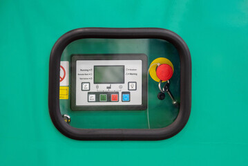 Control panel shows various buttons and a display on a machinery unit