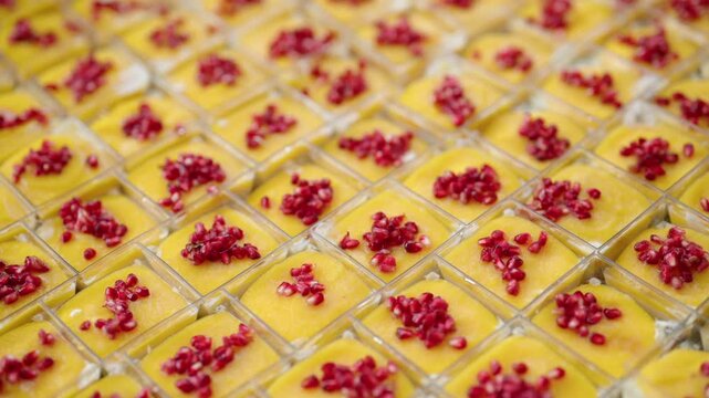 catering desserts with mango mousse and pomegranate seeds