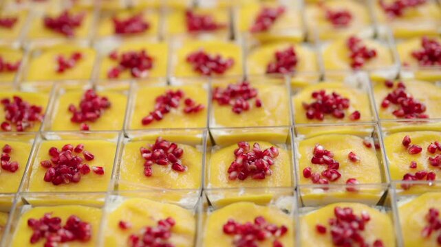 catering desserts with mango mousse and pomegranate seeds