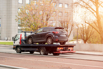 Tow Truck Transporting Disabled SUV With Engine Malfunction On Flatbed