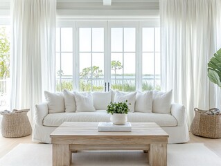 A white couch with white pillows sits in front of a coffee table