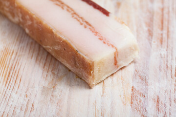 Appetizer salted pork bacon at wooden background, nobody