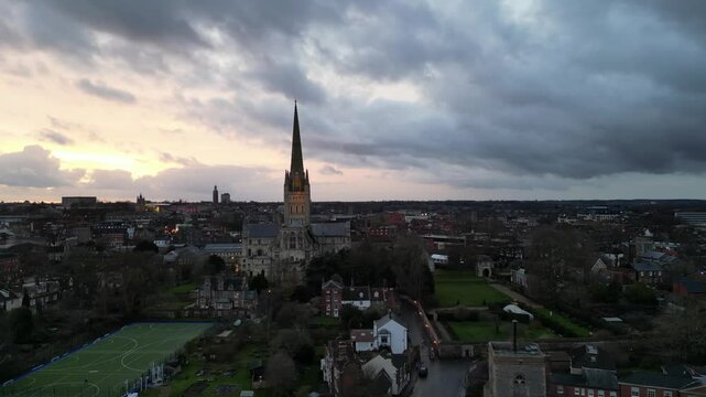 A breathtaking 4K drone swoop over Norwich, capturing the cathedral at sunset with the warm light of evening. Ideal for cinematic or atmospheric content featuring iconic architecture.

