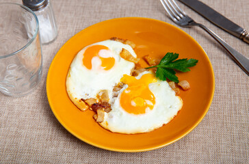 Appetizing breakfast with scrambled eggs and juicy bacon