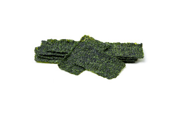 Fototapeta premium Crispy fried seaweed isolated on white background. Algae are plants that grow in lakes, rivers, and other bodies of water. Seaweed has many health benefits and is also a great snack for weight loss.