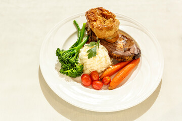 A plate of food with meat, vegetables, and potatoes