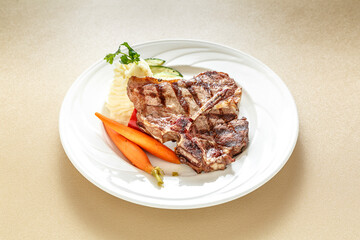 A plate of meat and vegetables, including carrots and a cucumber