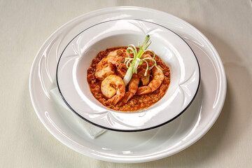 A plate of shrimp and rice with a green leaf on top