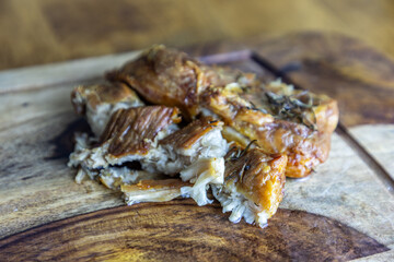 Crispy rosemary pork belly on a black walnut wood cutting board