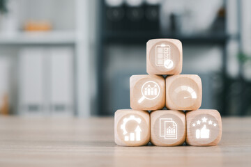 Wooden blocks with evaluation icons symbolizing business performance and strategy in a modern...