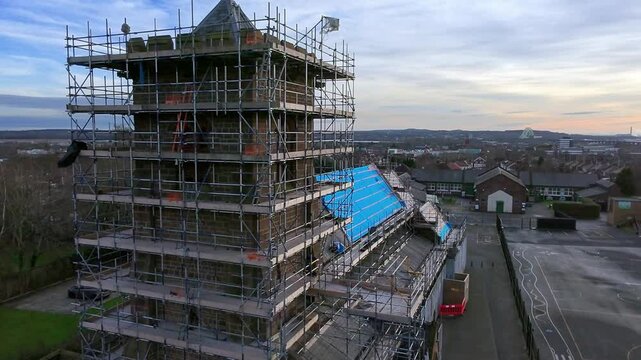 Church steeple tower scaffolding aerial view descending roof reconstruction framework