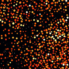 Abstract orange and red confetti on black background.
