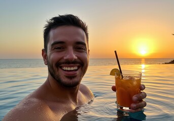 Smiling man enjoying sunset in infinity pool with refreshing cocktail